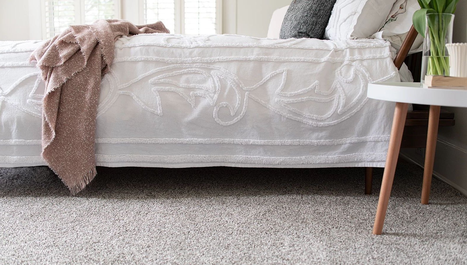 Bedroom with gray carpet from A Touch Of Magic Flooring in Emerald Isle, NC