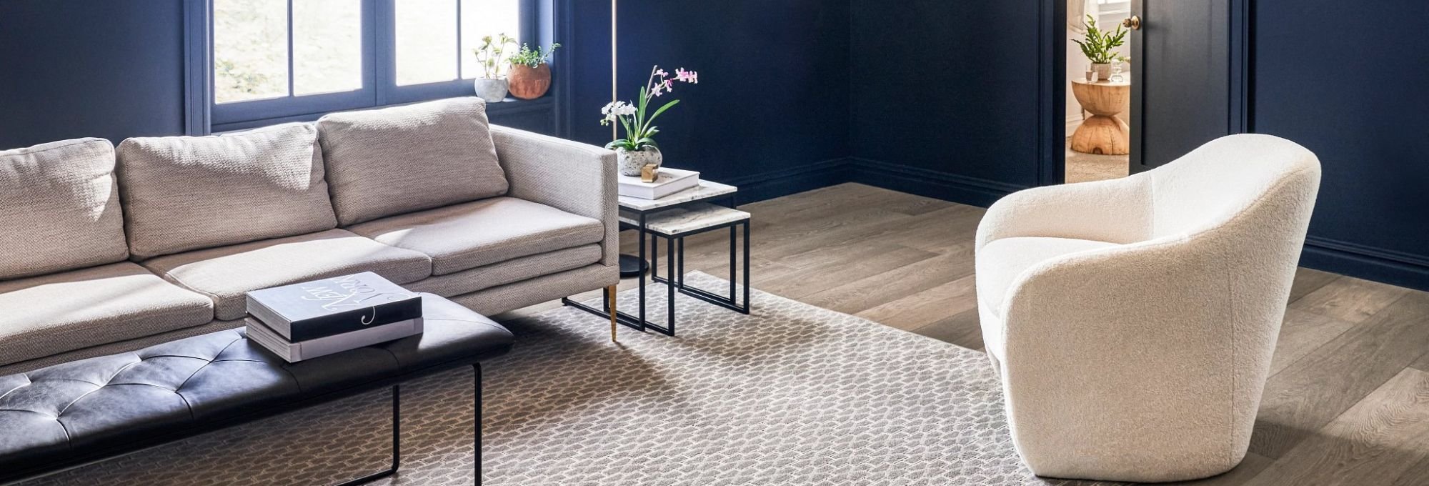 Living room with a large beige area rug from A Touch Of Magic Flooring in Emerald Isle, NC