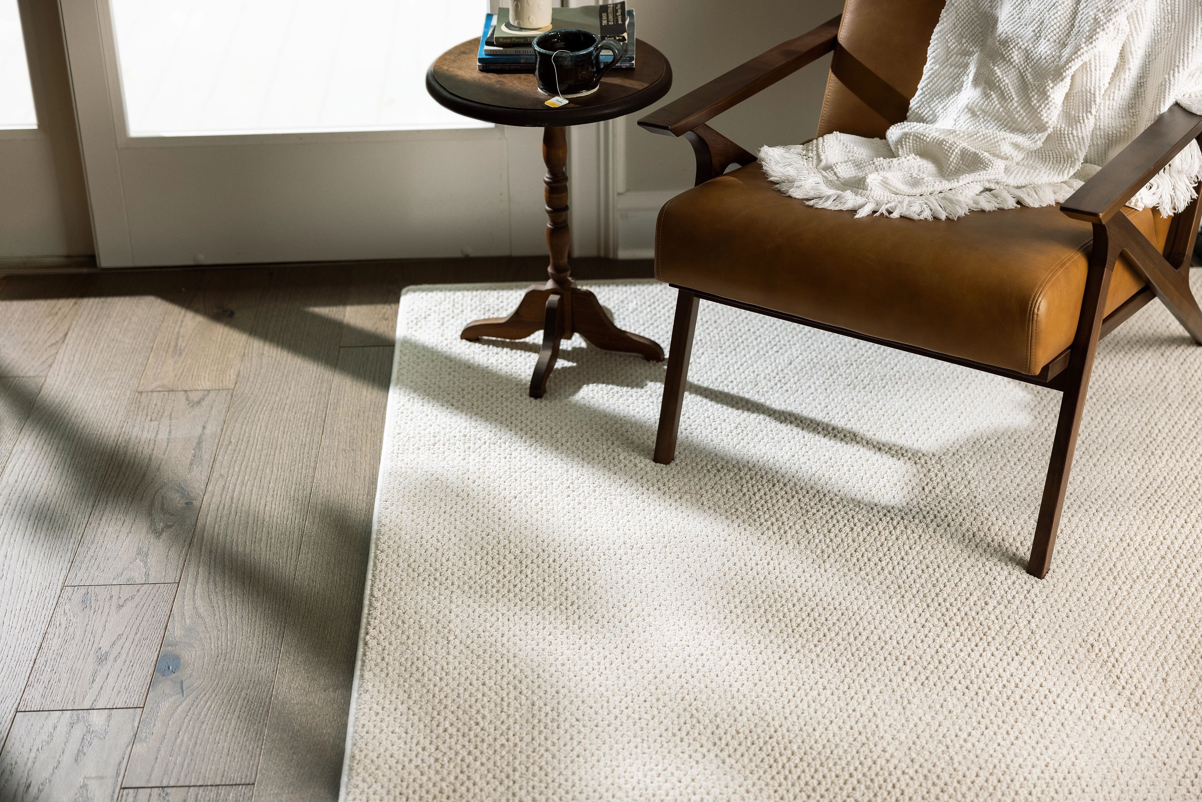 wood and leather chair on white area rug